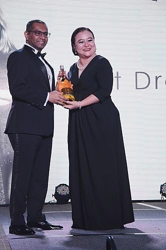 Dato’ Shaik Ismail Allaudin (Left) receiving his prize for the Best Dressed man of the night from Ms Christina Tan Soh Ann, Director of Communications.