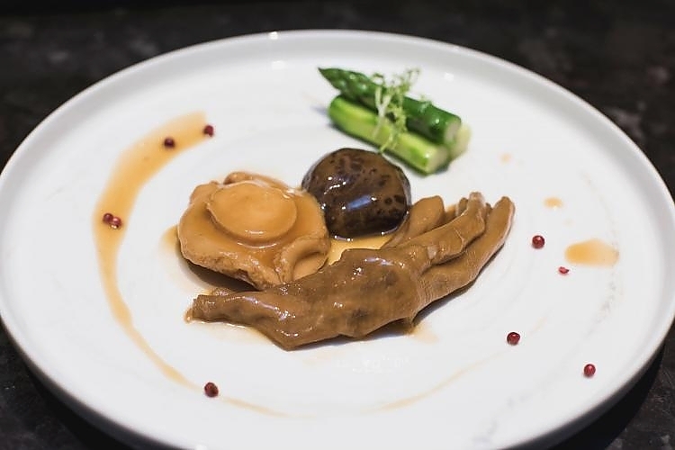 Braised abalone and Duck Web; A time consuming preparation process where the abalone is simmered with aged hen, Chinese ham, pork ribs and for approximately 8 hours and duck webbed feet. 