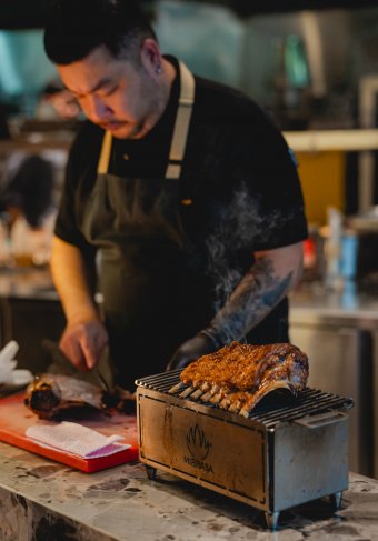Chef Han in his element — cooking Gundagai Lamb with restraint and precision to let the ingredient speak.